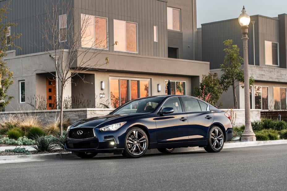 Very dark blue INFINTII Q50 Signature Edition in front of a residential building
